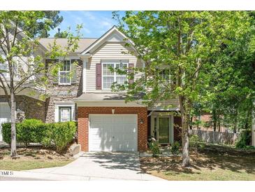 Charming two-story home boasts brick and siding, plus a one-car garage and inviting front entrance at 4240 Camden Woods Ct, Raleigh, NC 27612