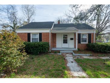 Charming single-story brick home with landscaped front yard and inviting entryway at 704 N King Charles Rd, Raleigh, NC 27610