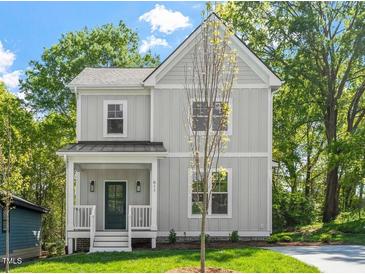 Charming two-story home with a cozy front porch and professionally landscaped yard at 811 Fargo St, Durham, NC 27707