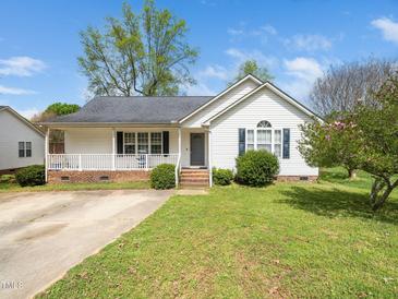 Charming single-story home featuring a cozy porch, landscaped front yard, and a classic white exterior at 104 Hamby Ct, Garner, NC 27529