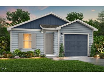 Charming single-Gathering home featuring blue vinyl siding, a covered entryway, and an attached garage at 123 Landon Pl, Roxboro, NC 27573