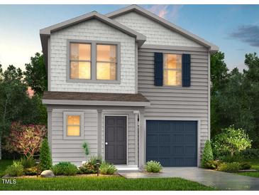 Charming two-story home with a combination of gray and white siding and a well-manicured lawn at 137 Lillian Ct, Roxboro, NC 27573
