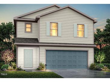 Two-story home featuring neutral siding, an attached garage, and a well-manicured front yard at 173 Lillian Ct, Roxboro, NC 27573