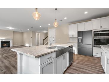 Beautiful kitchen featuring stainless steel appliances, a large island, and elegant pendant lighting at 1809 Harrell Cove Ct Ct # 181 Gunnison Fc, Fuquay Varina, NC 27526