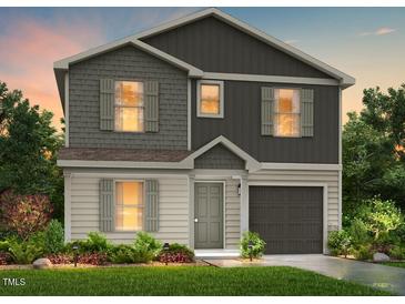 Charming two-story home featuring a landscaped yard and a two-car garage at 248 Lillian Ct, Roxboro, NC 27573
