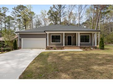 Charming single-story home featuring a garage and inviting front porch at 3011 Bourbon St, Sanford, NC 27332