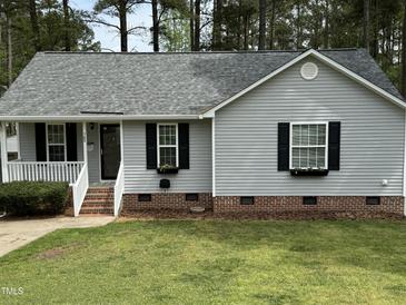 Charming single-Gathering home with gray siding, manicured lawn, and lovely curb appeal at 308 Caroline Dr, Wendell, NC 27591