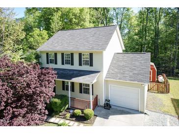 Charming two-story home with a front porch, attached garage, and well-maintained landscaping at 3819 Valleydale Dr, Durham, NC 27703