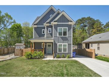 Charming two-story home with gray siding, white trim, covered porch, and a well-manicured front yard at 3908 Booker Ave, Durham, NC 27713