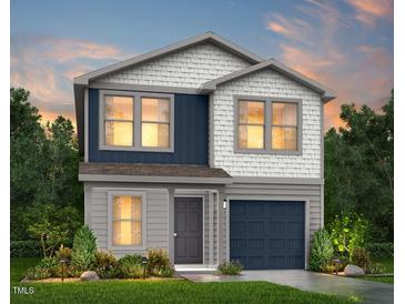 Charming two-story home with a mix of siding and shake exterior and a welcoming front yard at 52 Landon Pl, Roxboro, NC 27573