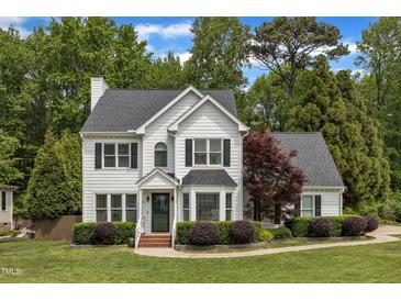 Charming two-story home with a well-manicured lawn and mature trees at 1005 Thorncroft Ln, Apex, NC 27502
