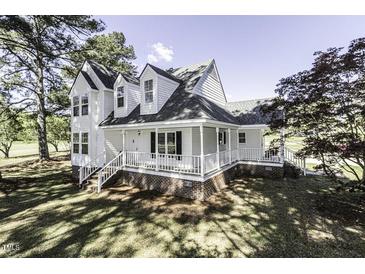 Charming two-story home with a covered front porch and well-maintained lawn and mature trees at 2122 Pleasant Hill Rd, Rocky Mount, NC 27801