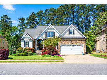 Charming home featuring manicured landscaping, a two-car garage, and stone accents on the exterior at 215 Terrell Dr, Rolesville, NC 27571
