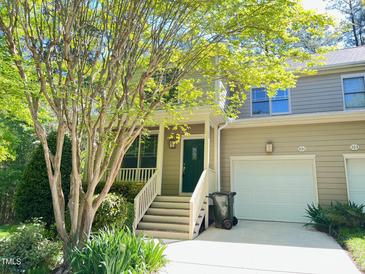 Charming townhome with a well-maintained front yard and a one car garage at 301 Charleston Ln, Chapel Hill, NC 27517