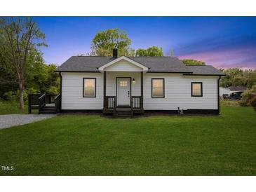 Charming single-story home with a well-maintained lawn and inviting front porch at 326 W Gilbreath St, Graham, NC 27253