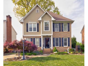Charming two-story home with brick and siding, dark shutters, and a landscaped front yard at 3517 Elk St, Burlington, NC 27215