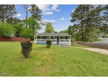 Charming single story home with a covered front porch and a large grassy front yard at 423 Orange Heights Rd, Hillsborough, NC 27278