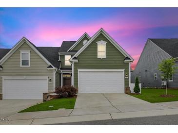 Charming home featuring a two-car garage, well-manicured lawn, and inviting curb appeal at 518 Judge Ct, Durham, NC 27703
