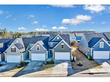 Exterior shot of attractive homes with well-maintained lawns and colorful facades at 518 Judge Ct, Durham, NC 27703