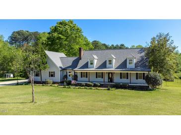 Charming two-story home featuring a welcoming front porch and lush, green lawn at 530 Turlington Rd, Dunn, NC 28334
