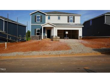 Two-story home exterior with blue and gray siding and a two-car garage in a construction phase at 708 Deschutes Dr, Garner, NC 27529