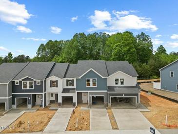 New townhomes feature modern designs, attached garages, and beautiful landscaping at 1048 Winding Spring Dr, Mebane, NC 27302