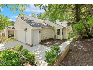 Charming home featuring a garage, manicured landscaping and neutral siding at 108 Woodglen Dr, Cary, NC 27518