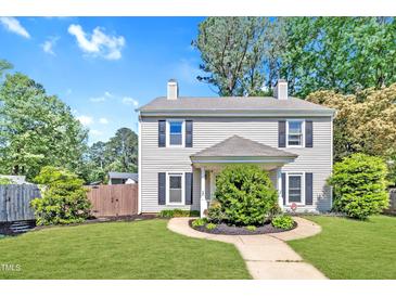 Charming two-story home featuring a well-manicured lawn and traditional architectural details at 121 Drumbuie Pl, Garner, NC 27529