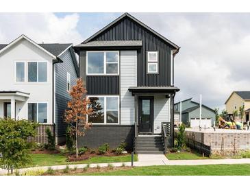 Charming two-story home with a modern black and gray exterior and well-manicured lawn at 14 Relaxing Way, Pittsboro, NC 27312