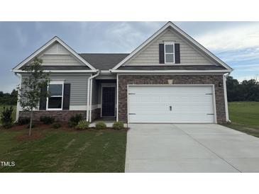 Charming single-Gathering home with stone accents, a two-car garage, and a well-manicured lawn at 182 E Victory View Ter, Smithfield, NC 27577