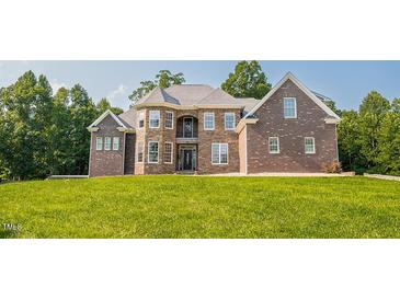 Stunning brick home with meticulously manicured lawn and stone accents at 3704 Hesters Store Rd, Hurdle Mills, NC 27541