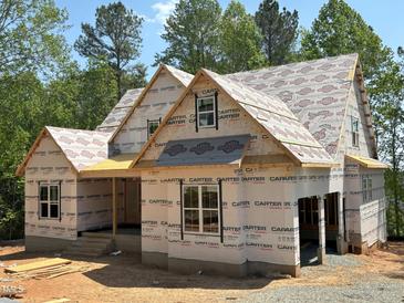 New construction home showing roof sheathing and framing, with windows and covered porch at 485 Chapel Ridge Dr, Pittsboro, NC 27312
