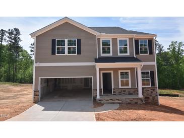Two-story home featuring stone accents, a two-car garage, and a neutral color scheme at 75 Cordoba Dr, Franklinton, NC 27525