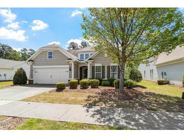 Charming single-Gathering home featuring a manicured front yard and attached two-car garage at 792 Eldridge Loop, Cary, NC 27519