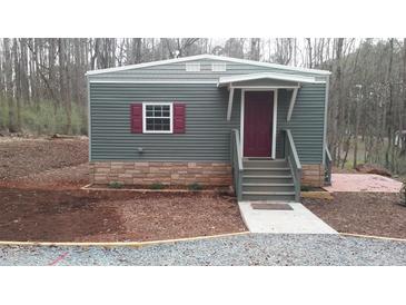 Charming single-story home with gray siding, burgundy shutters, and a landscaped yard at 82 Whisper Ln, Pittsboro, NC 27312