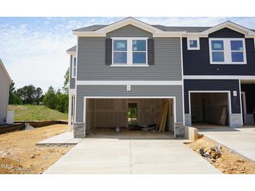 New construction townhome featuring a two-car garage and light gray horizontal siding at 1054 Winding Spring Dr, Mebane, NC 27302