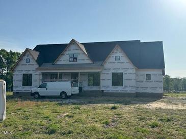 New construction home showing the exterior with a work van parked nearby at 11226 Old Beulah Rd, Kenly, NC 27542