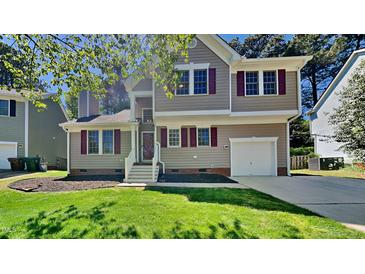 Charming two-story home with a well-manicured lawn and inviting curb appeal, featuring red shutters and a one car garage at 113 Union Mills Way, Cary, NC 27519