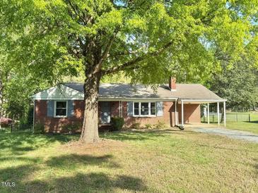 Charming one-story brick home with well-manicured lawn and a covered carport at 131 Rosewood Dr Dr, Roxboro, NC 27573