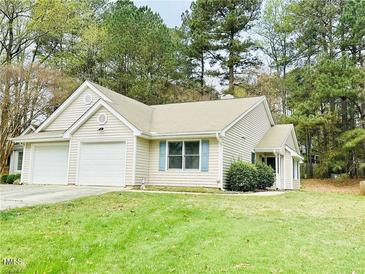 Charming single-story home featuring a two-car garage, tidy lawn, and inviting curb appeal at 203 Standish Dr, Chapel Hill, NC 27517