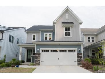 Charming two-story home with a two-car garage and stone accents at 2089 Florine Dr, Apex, NC 27502