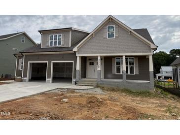 Charming two-story home showcasing a spacious two-car garage and inviting front porch at 2320 Eagle Shot Ct # 20, Fuquay Varina, NC 27526