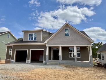 New two-story home with a two-car garage, covered porch, and neutral brown and gray color scheme at 2320 Eagle Shot Ct # 20, Fuquay Varina, NC 27526