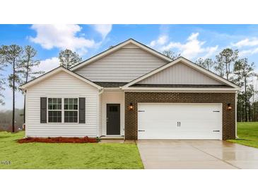 Charming single-Gathering home showcasing a brick and vinyl exterior with a two-car garage at 2736 Luxborough Ln, Mebane, NC 27302