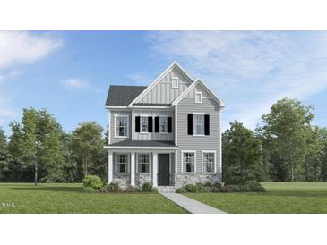 Charming two-story home with a gray exterior, black shutters, stone accents, and lush green landscaping at 320 Canyon Spring Trl, Wake Forest, NC 27587