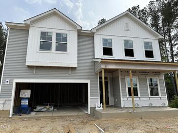 New two-story home showing gray siding, white trim, and an attached two-car garage at 4008 Shadbush St, Raleigh, NC 27616