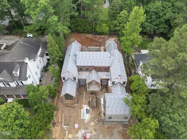 Expansive new construction featuring a brick facade, detailed roofline, and lush surrounding greenery at 516 Transylvania Ave, Raleigh, NC 27609