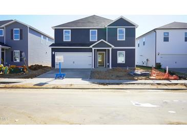 Charming two-story home with a two-car garage and a well-maintained lawn at 630 White Birch Ln, Angier, NC 27501
