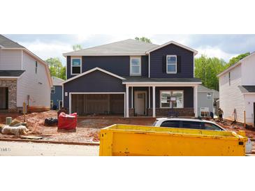 New two story home with blue siding and an attached two car garage at 705 Deschutes Dr Dr, Garner, NC 27529