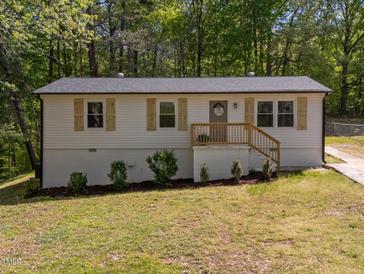 Charming single-story home with wood shutters, a well-maintained lawn and refreshed landscaping at 120 King Charles Rd, Hillsborough, NC 27278